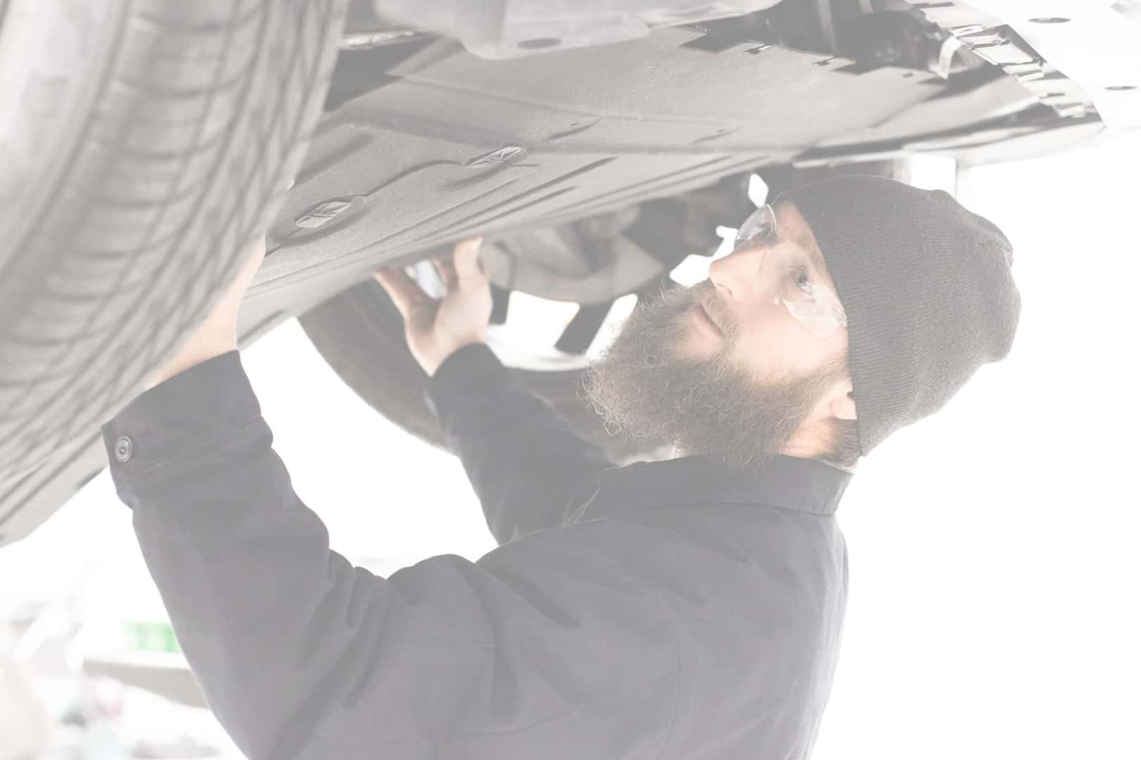land rover service technician under car