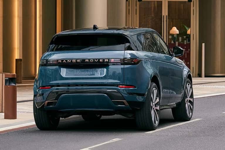 2025-land-rover-range-rover-evoque-parked-on-city-street-with-man-mobile
