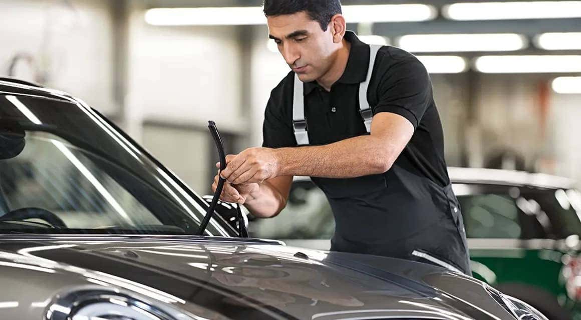 MINI technician replacing wiper blades on a vehicle