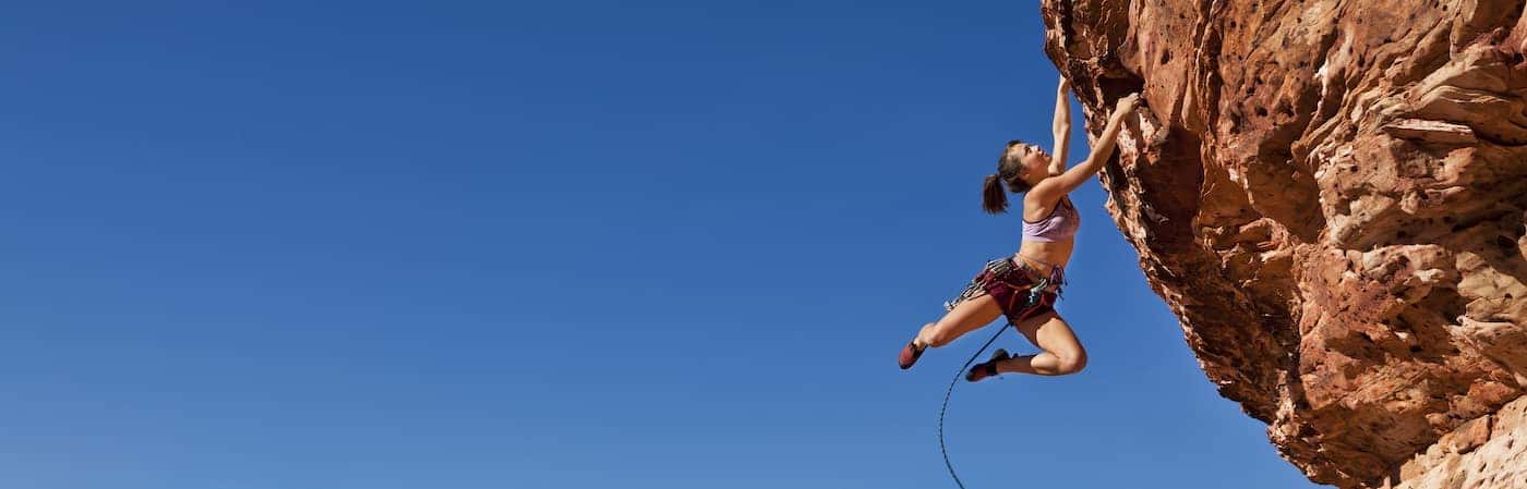 Woman Climbing rocks
