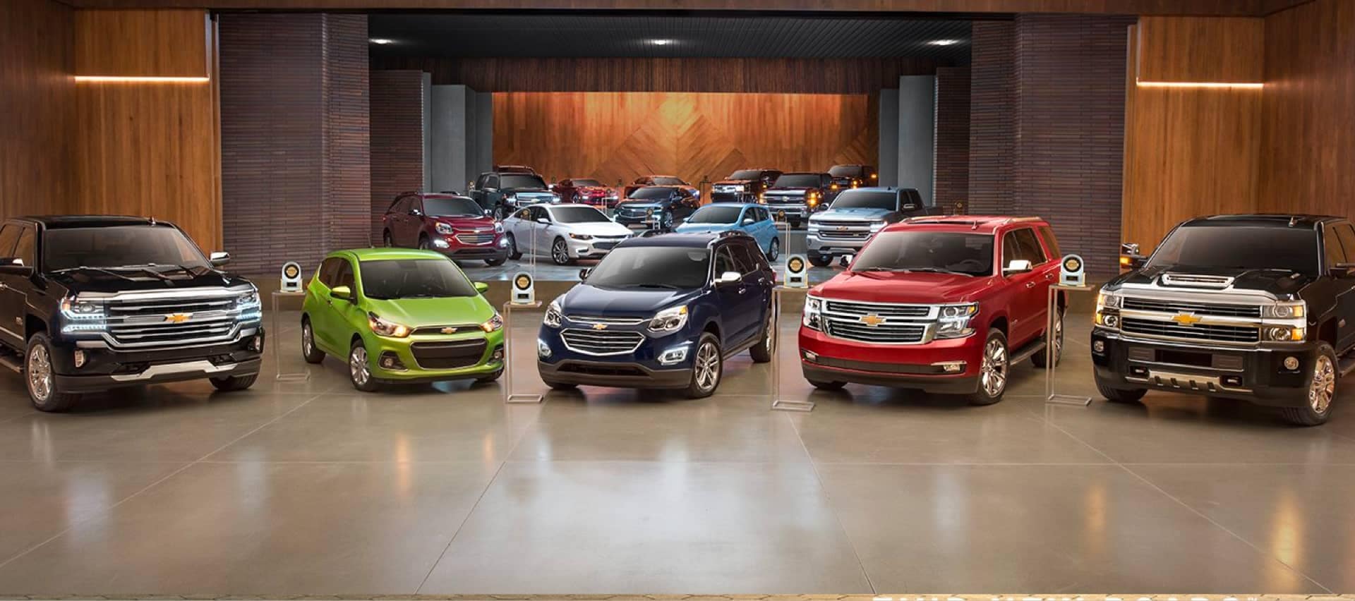 The 2020 Chevrolet model lineup comprised of their most popular vehicles An exterior shot of a Chevrolet dealership at night.