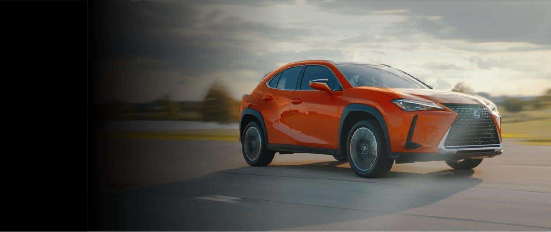 Orange Lexus SUV outside in dust