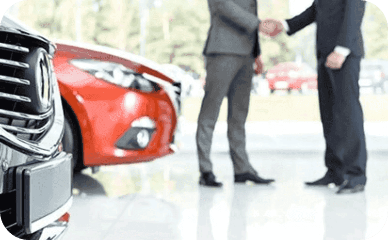 Two men in suits in a dealership