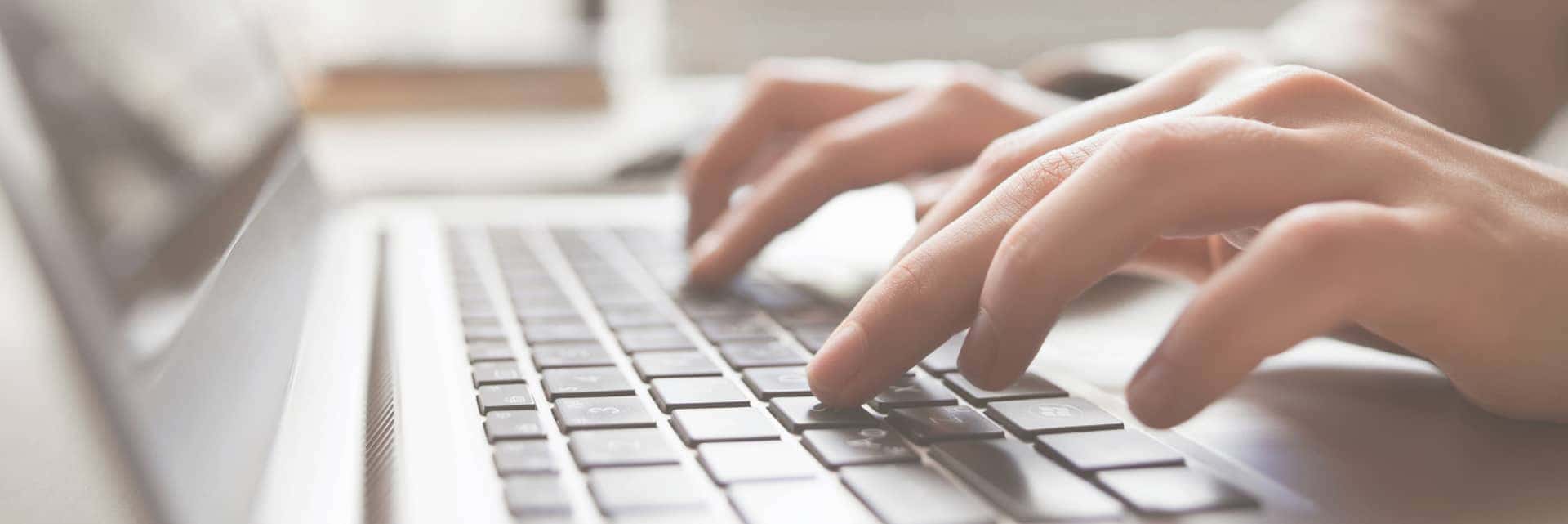 Person typing on laptop