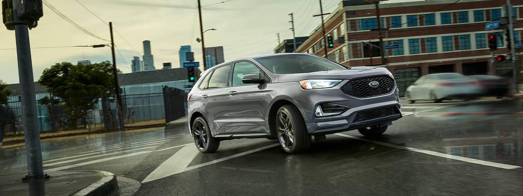 Front passenger view of a Silver 2022 Ford Edge on an urban road-hero