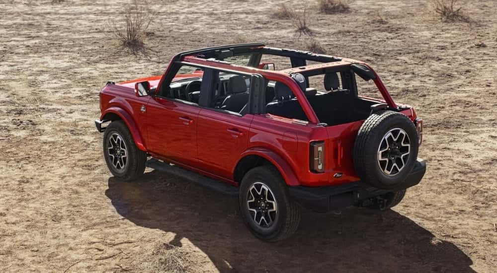 A red 2023 Ford Bronco is shown from the side parked after leaving a Ford dealer near you.