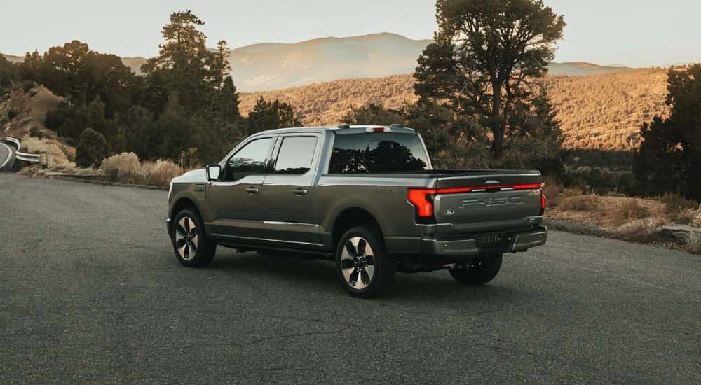 A grey 2023 Ford F-150 Lightning is shown parked on pavement after visiting a Ford dealership serving Athens, GA.