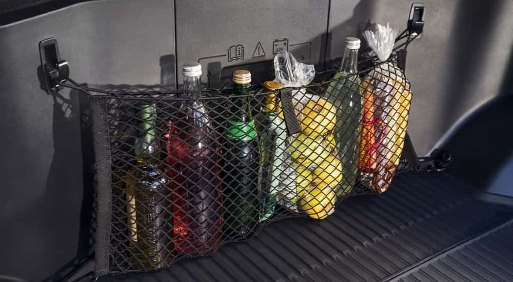 A close-up shows beverages in a 2022 Ford F-150 Lightning. 