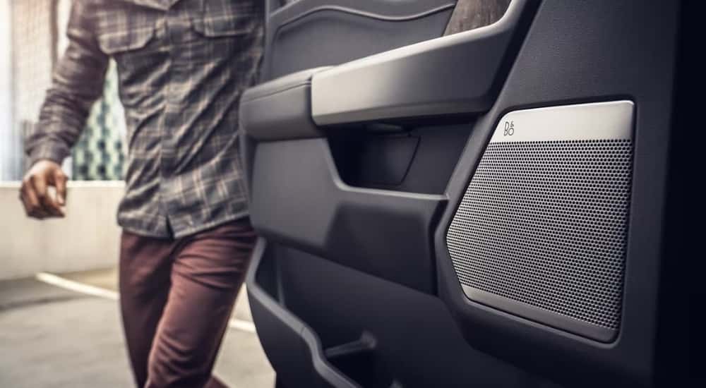 A close-up shows the black and silver door card in a 2022 Ford F-150 Lightning.