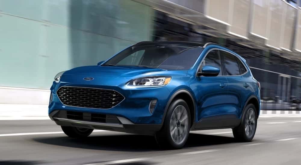 A blue 2022 Ford Escape is shown driving on a city street.