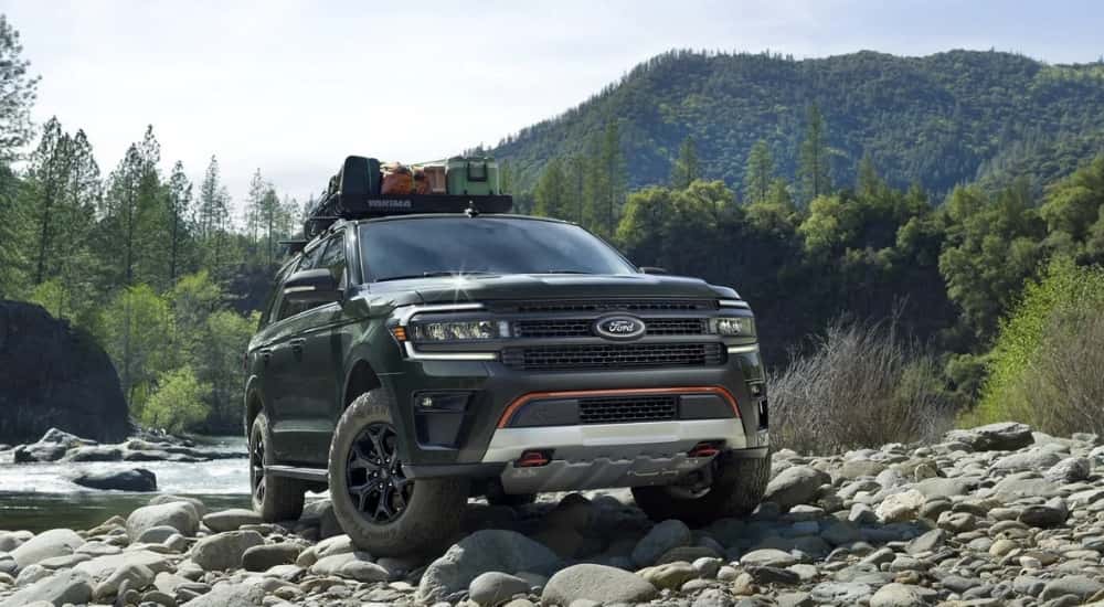 A green 2023 Ford Expedition Timberline is shown near a river.