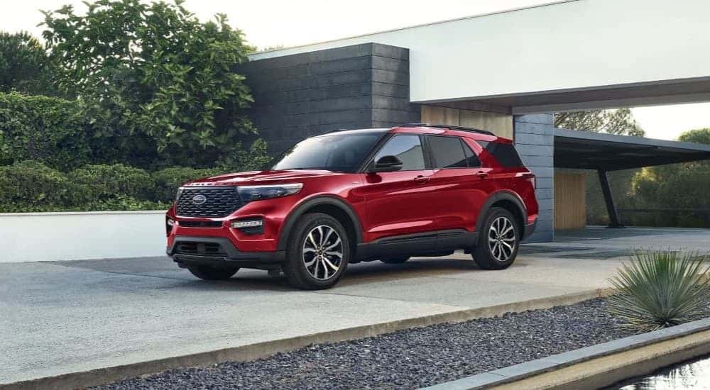 A red 2023 Ford Explorer is shown parked in a driveway after visiting a Monroe Ford dealer.