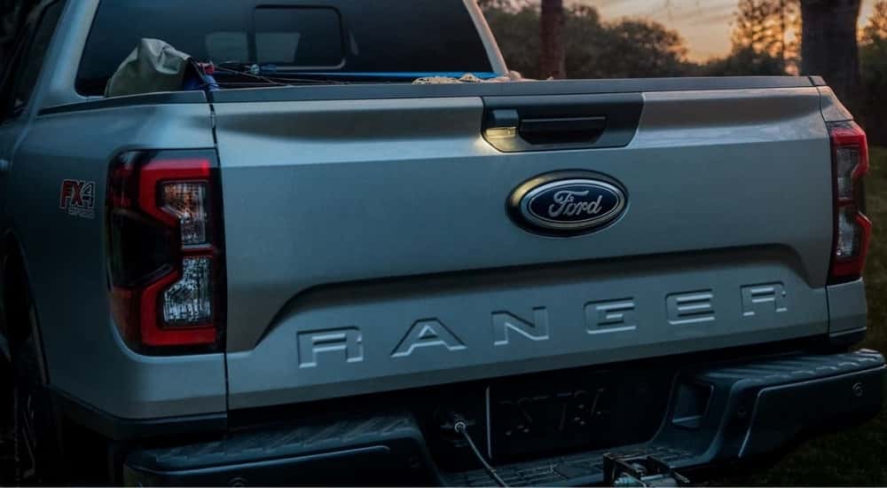 A close-up shows the tailgate on a silver 2024 Ford Ranger FX4.