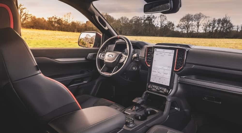 The black interior with orange details are shown in a 2024 Ford Ranger Raptor.