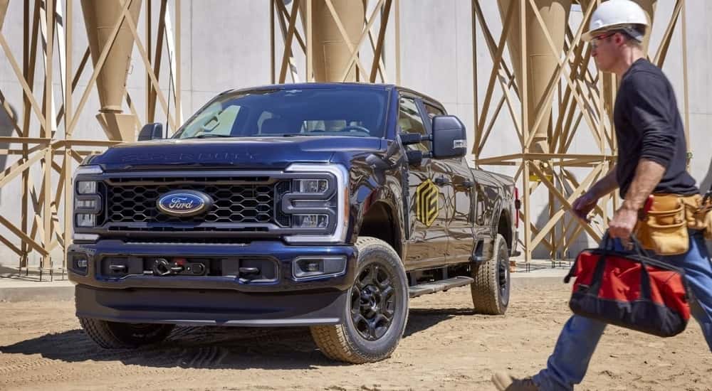 A blue 2023 Ford F-250 STX is shown parked at a construction site after leaving a Ford dealer near Covington.