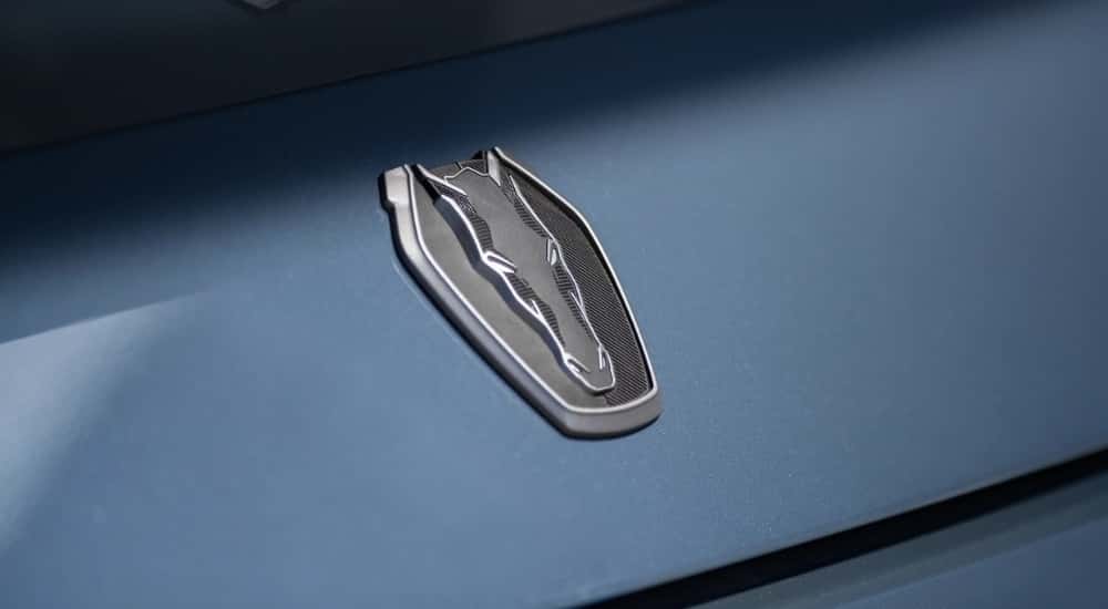 A close up shows a trunk badge on a blue  2024 Ford Mustang Dark Horse.
