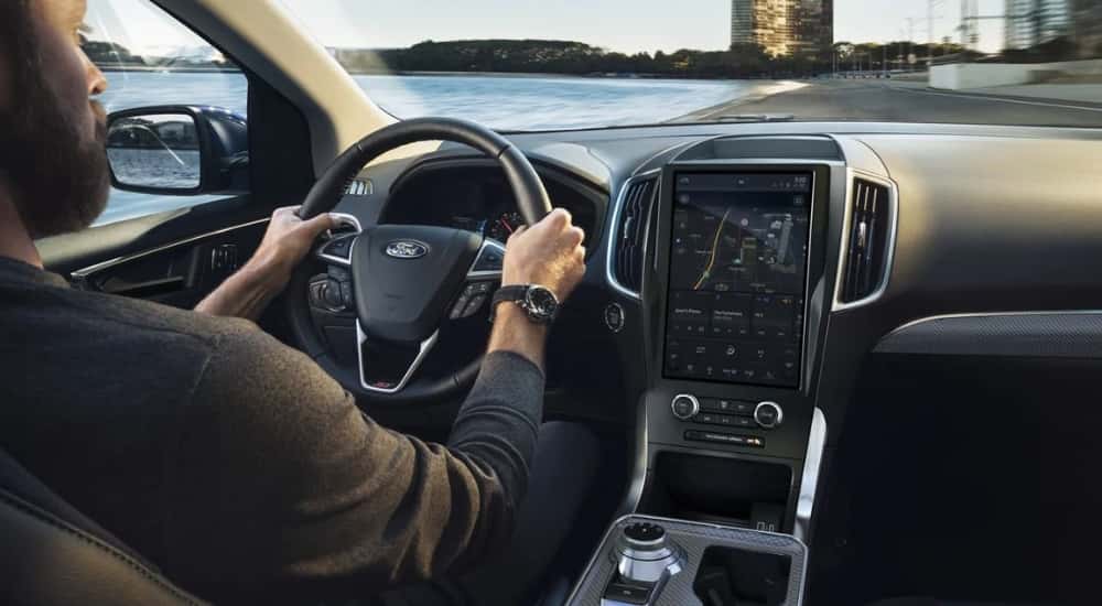 A person is shown driving a 2023 Ford Edge to a Ford dealer near Stockbridge.