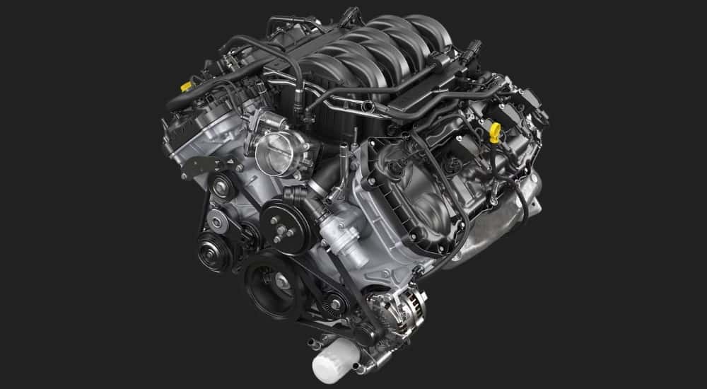 A close up shows a 5.0L V8 engine for a 2024 Ford F-150.
