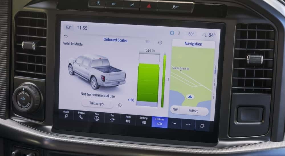 A close-up shows the infotainment screen in a 2024 Ford F-150.