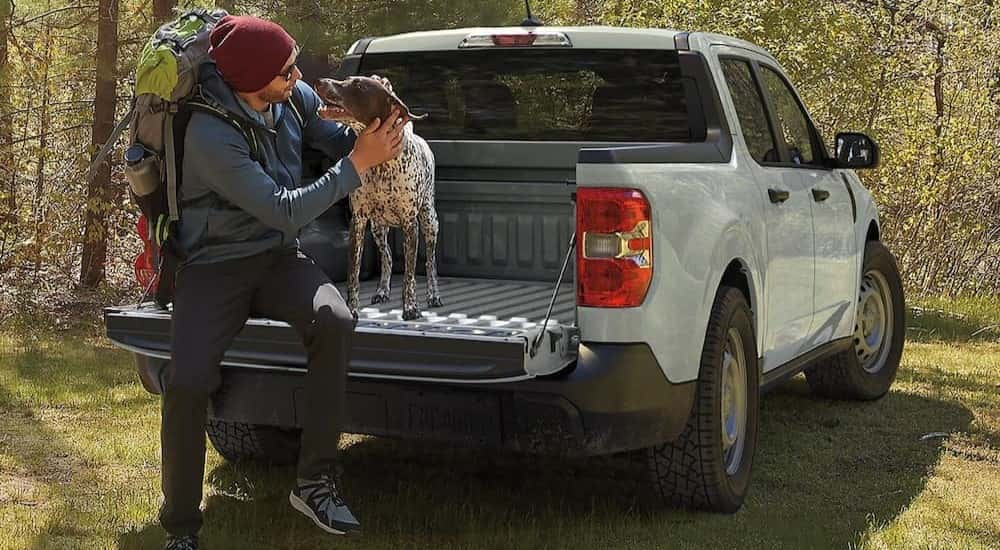 A gray 2024 Ford Maverick is shown parked off-road.