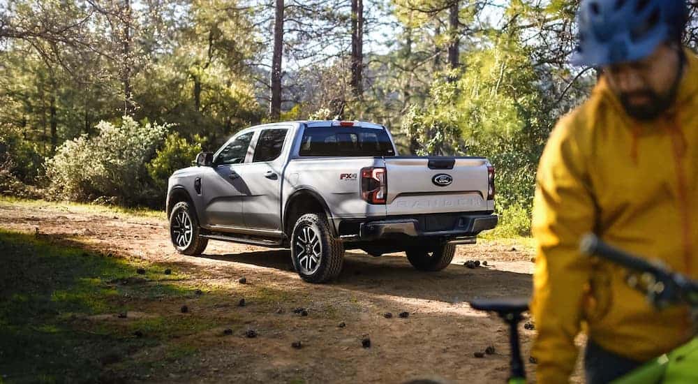 A grey 2024 Ford Ranger is parked near a biking trail.