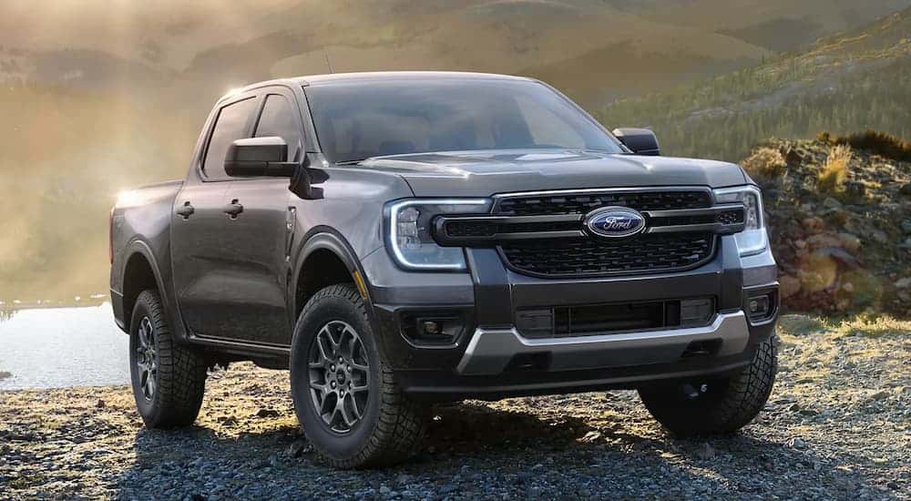 A grey 2024 Ford Ranger XLT parked on gravel.
