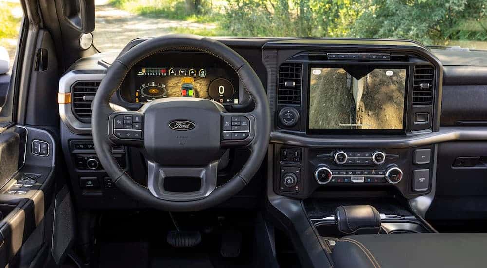 The black interior of a 2025 Ford F-150 Tremor is shown from the driver's seat.