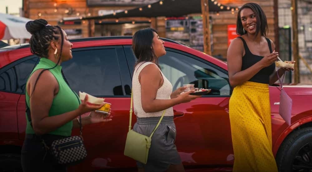 People are shown walking past 2025 Ford Escape.