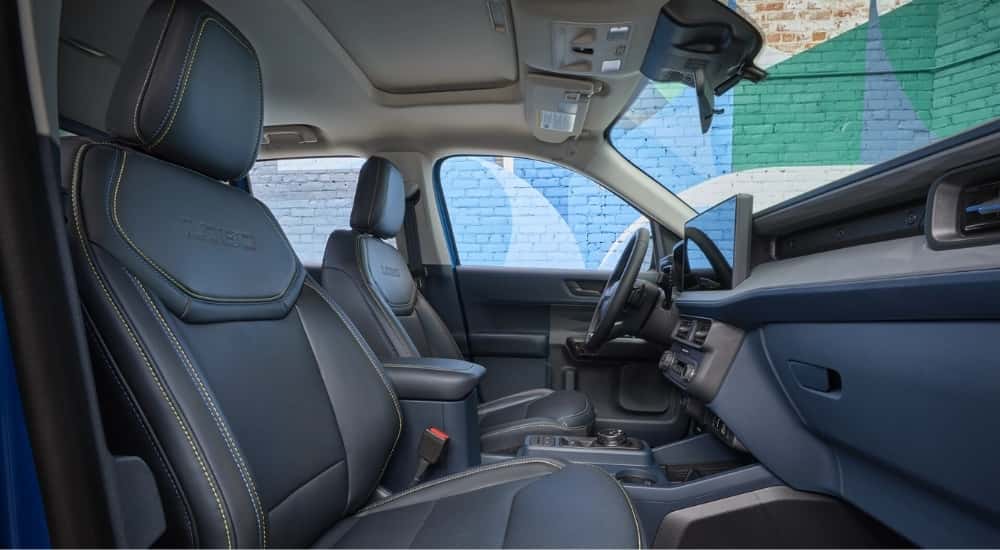 The black leather interior is shown in a blue 2025 Ford Maverick Lobo.