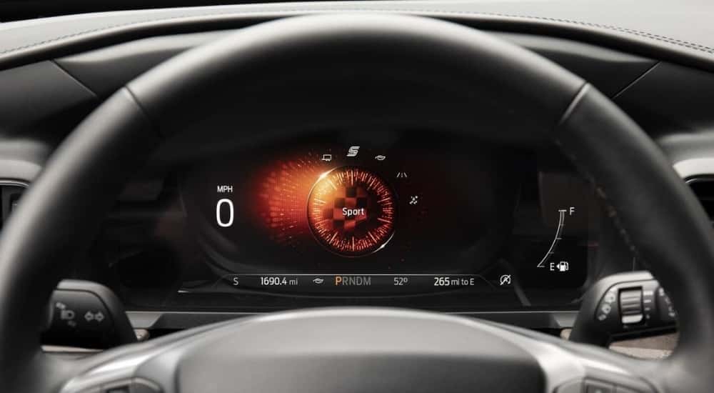A close-up shows sport mode on the digital gauge in a 2021 Ford Explorer.