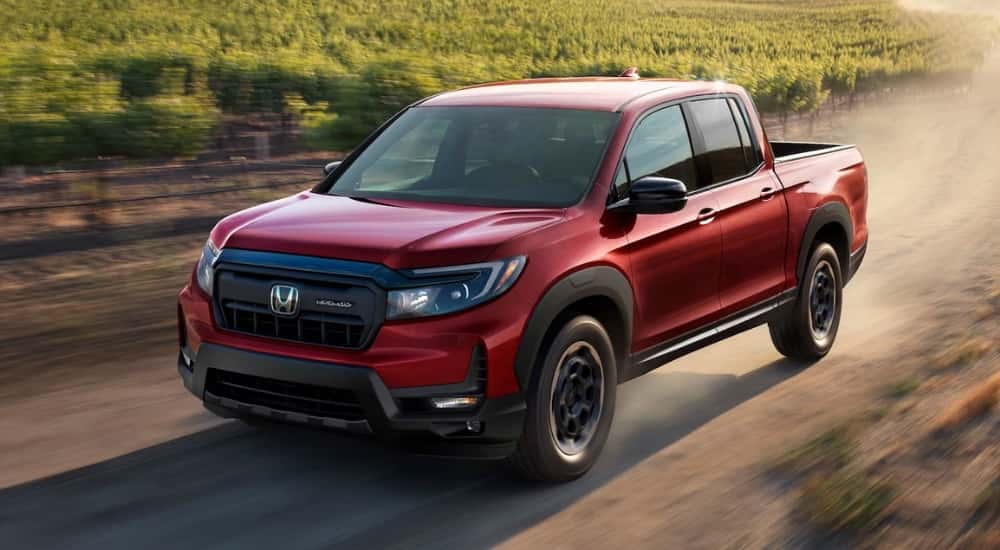 A red 2024 Honda Ridgeline HPD is shown.