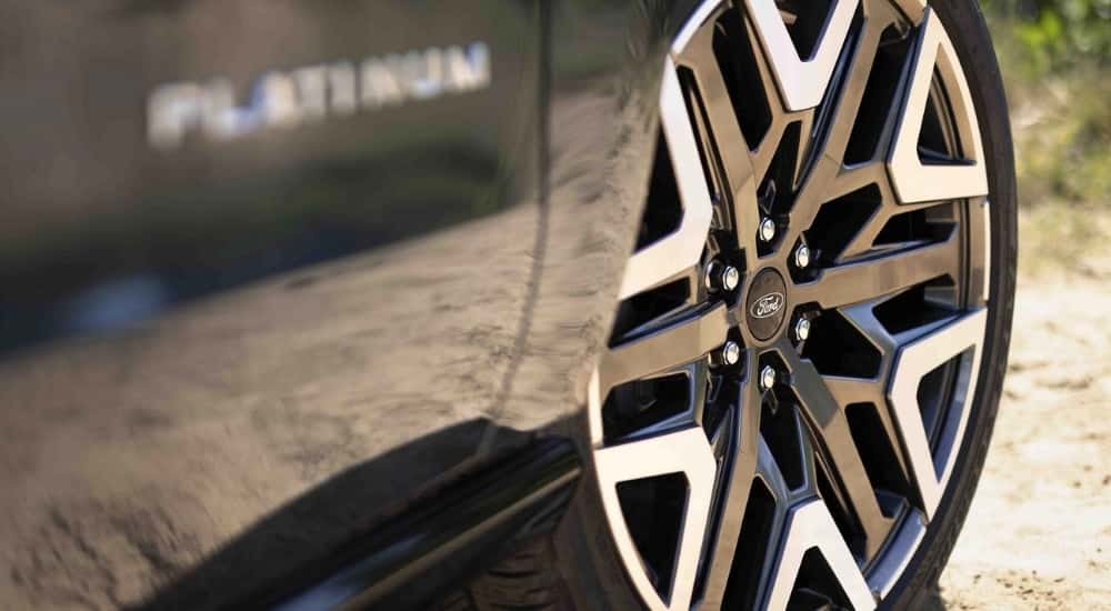 A close up shows a wheel on a grey 2025 Ford Expedition Platinum.