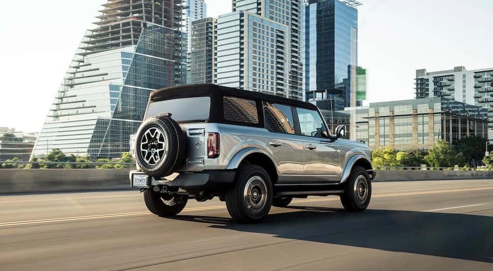 A silver 2021 Ford Bronco is shown from the rear at an angle.