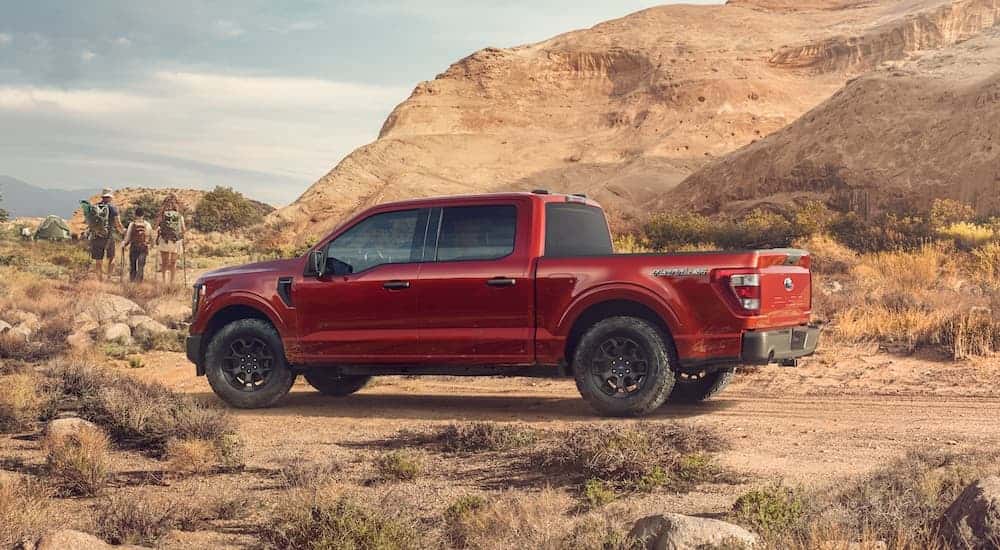 A red 2023 Ford F-150 Rattler is shown from the side after leaving a Ford dealer near Loganville.