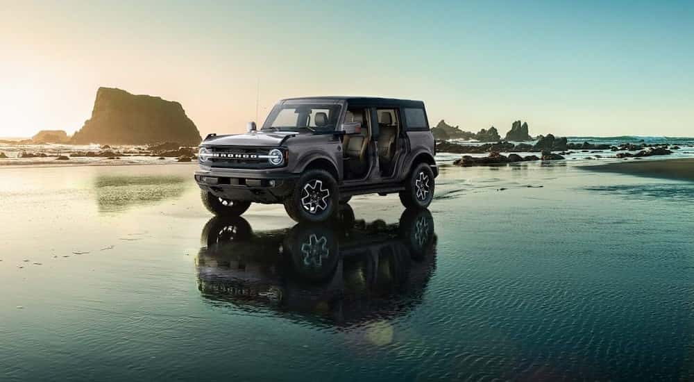 A 2024 Ford Bronco is shown parked on a beach.