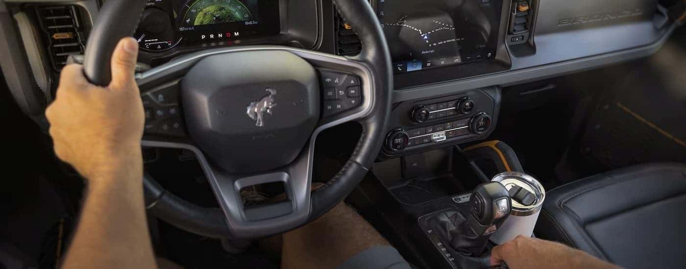 A first person view of a driver in the front seat of a 2024 Ford Bronco.