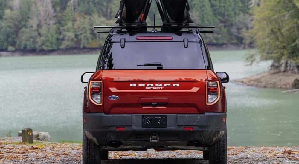 A red 2024 Ford Bronco Sport is shown parked near a lake.