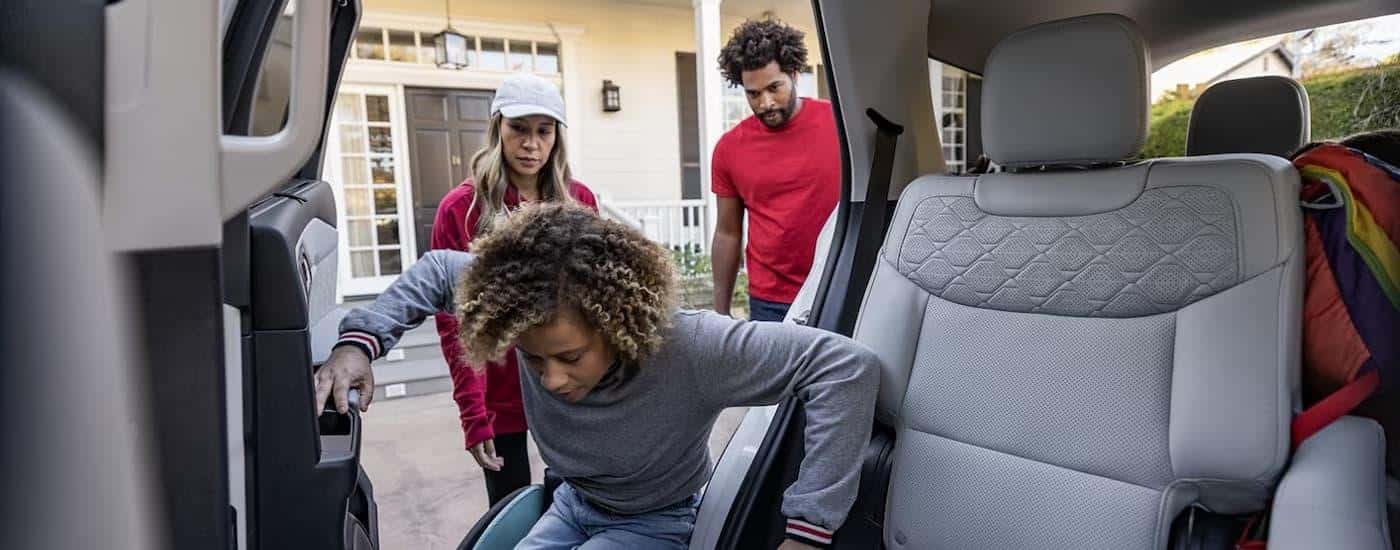A child is getting into the back seat of a 2025 Ford Explorer.
