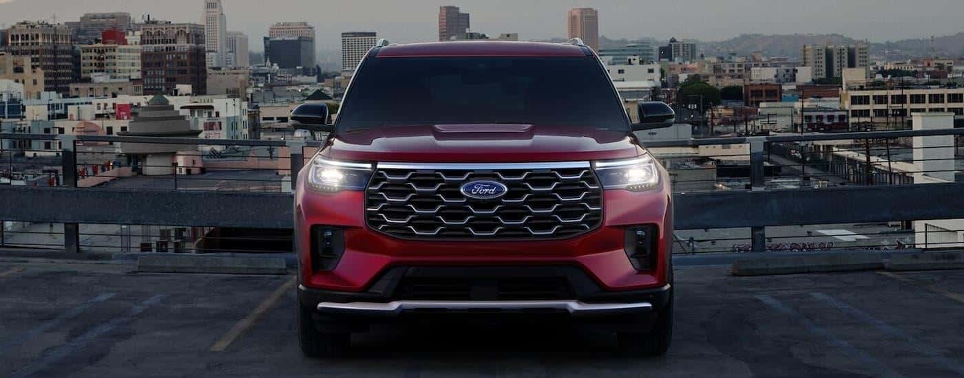 A red 2024 Ford Explorer parked on top of a rooftop lot.