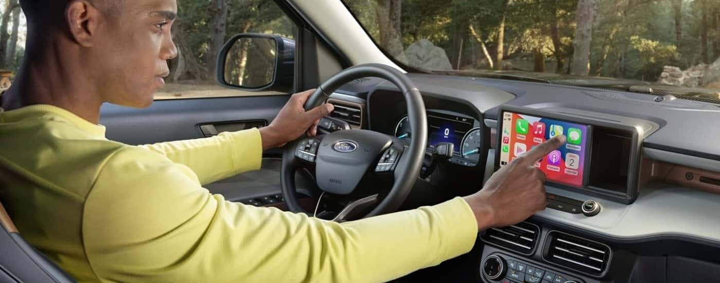 A man is shown using the infotainment screen in a 2024 Ford Maverick.