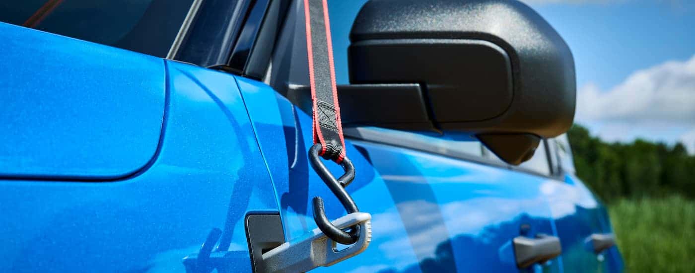 A close up of the side and mirror on a blue 2025 Ford Bronco Sport Badlands.