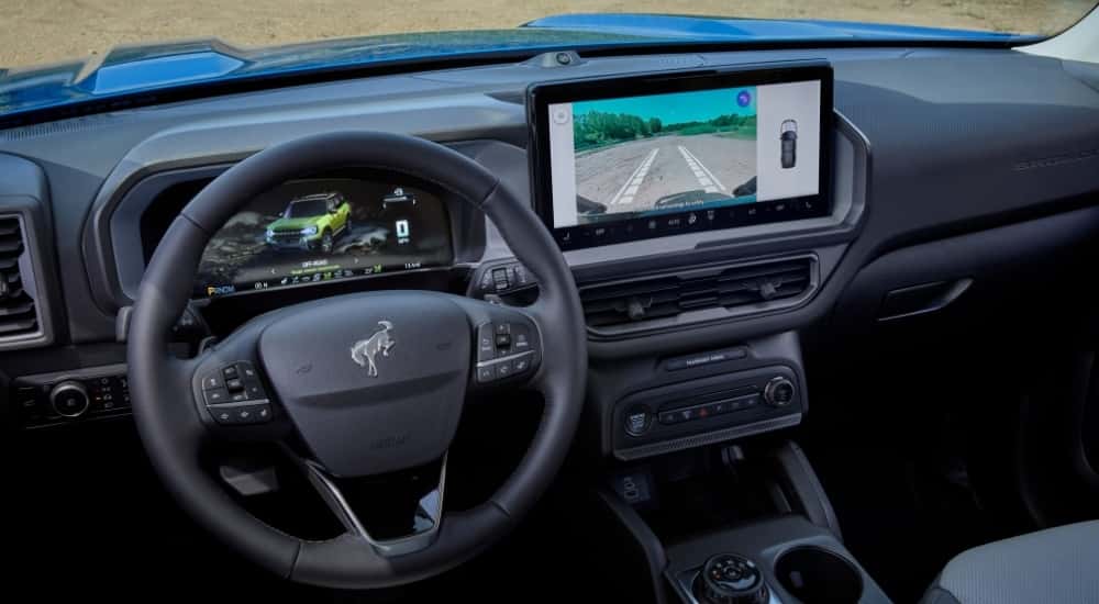 The steering wheel and infotainment screen in a 2025 Ford Bronco Sport Badlands Sasquatch.