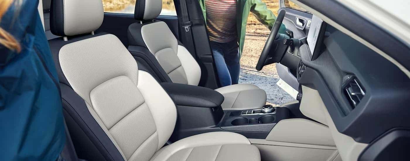People are getting into the front seats of a 2025 Ford Escape.