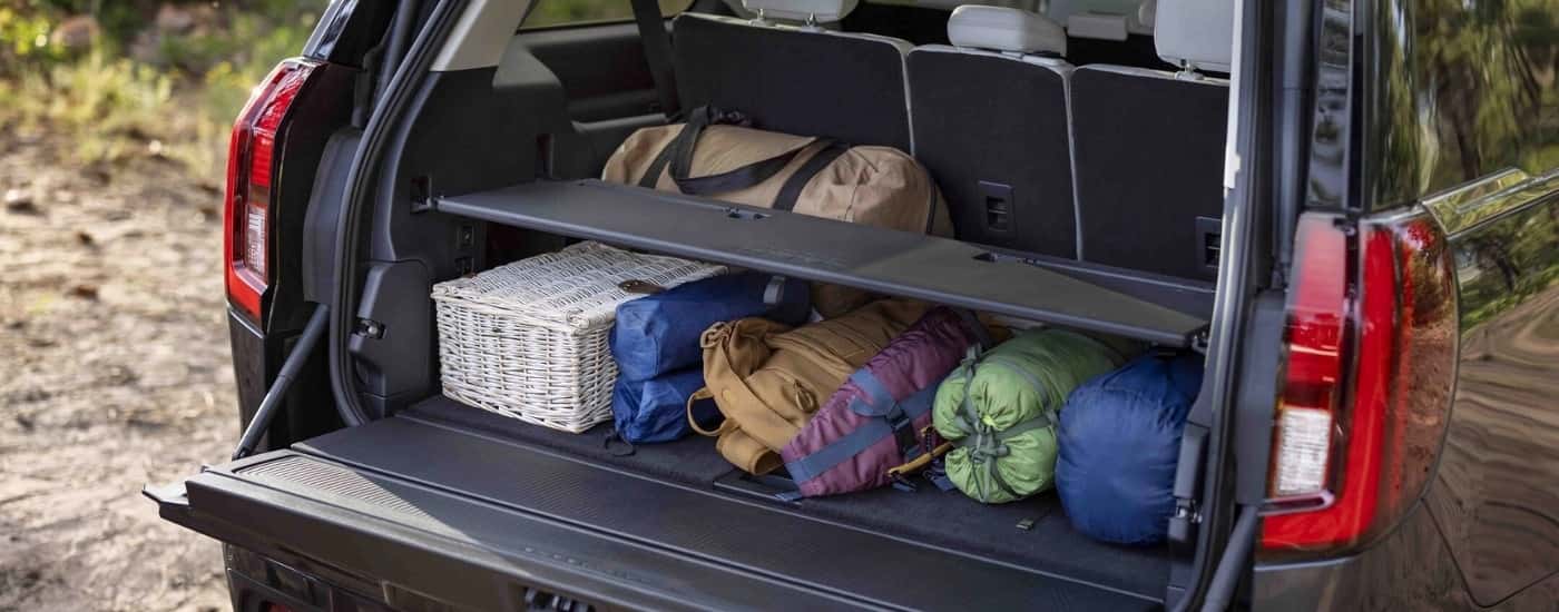 A load of camping gear is in the cargo space of a black 2025 Ford Expedition Platinum.