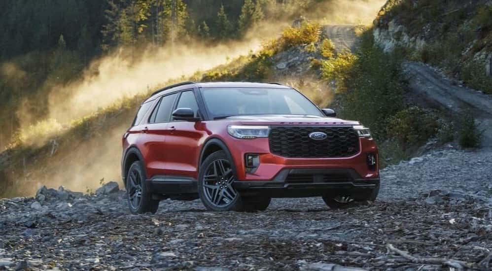 A red 2025 Ford Explorer ST is shown parked off-road.