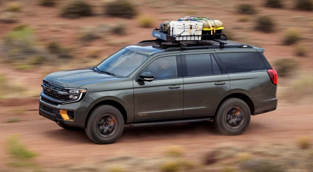 A green 2025 Ford Expedition Tremor is shown from the side.