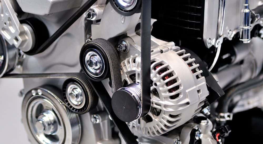 The engine block of a car, showing the alternator.