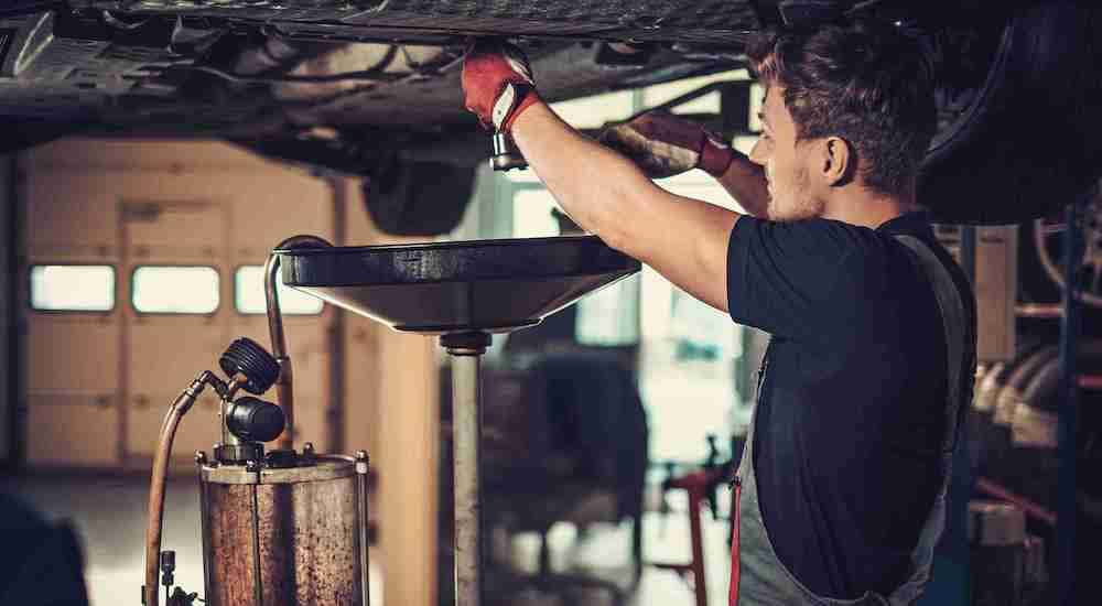 A tech is shown performing auto repair near Monroe.