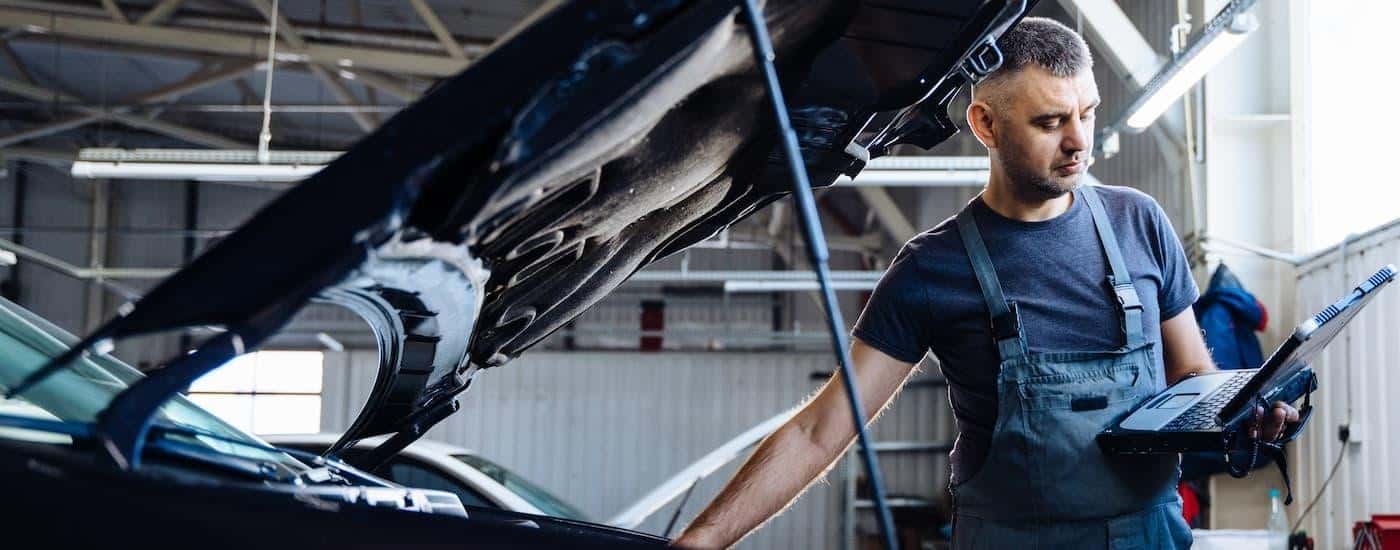 A mechanic working on a vehicle at an auto repair shop.