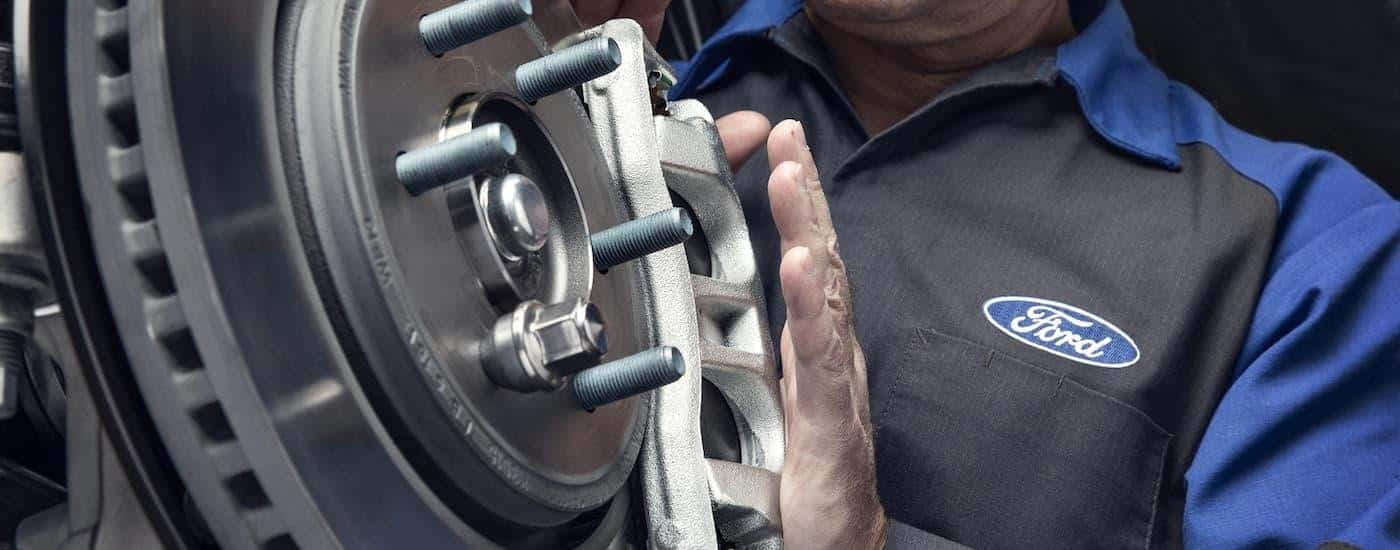 A Ford mechanic is shown inspecting brakes at an auto repair shop in Loganville.